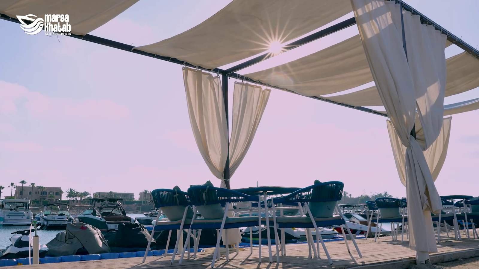 Waterfront lounge seating area at golden hour