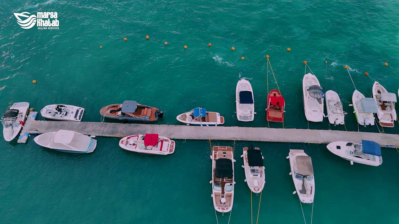Aerial view of boats moored along the marina pier