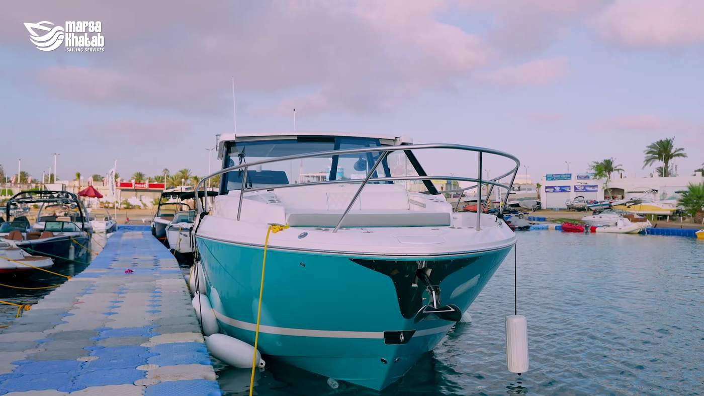 Teal-hulled yacht docked at Marsa Khatab Marina